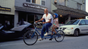 Bald Man and Child on Tandem Bike in Downtown Rutland